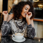 African american woman enjoying coffee after laser hair removal vs electrolysis near Naperville