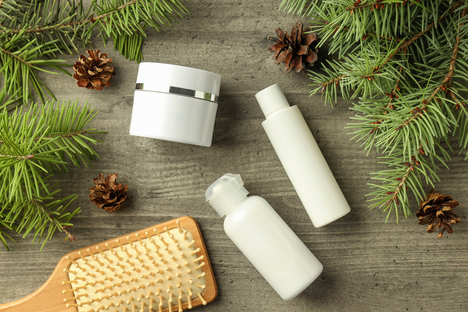 non branded winter skin care products surrounded by pine needles
